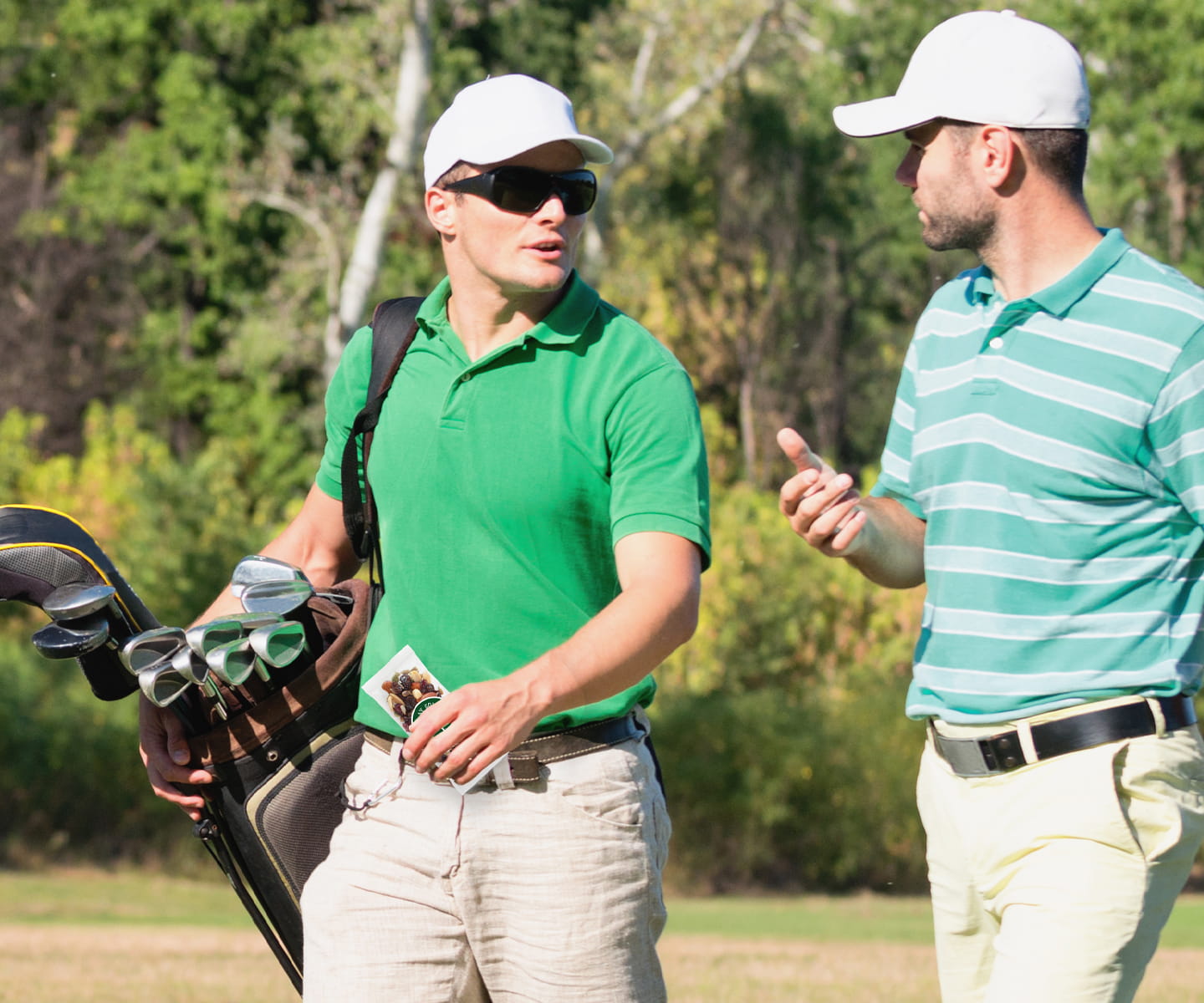 Golf attendant greeting members at luxury clubhouse with Torn Ranch snack display.