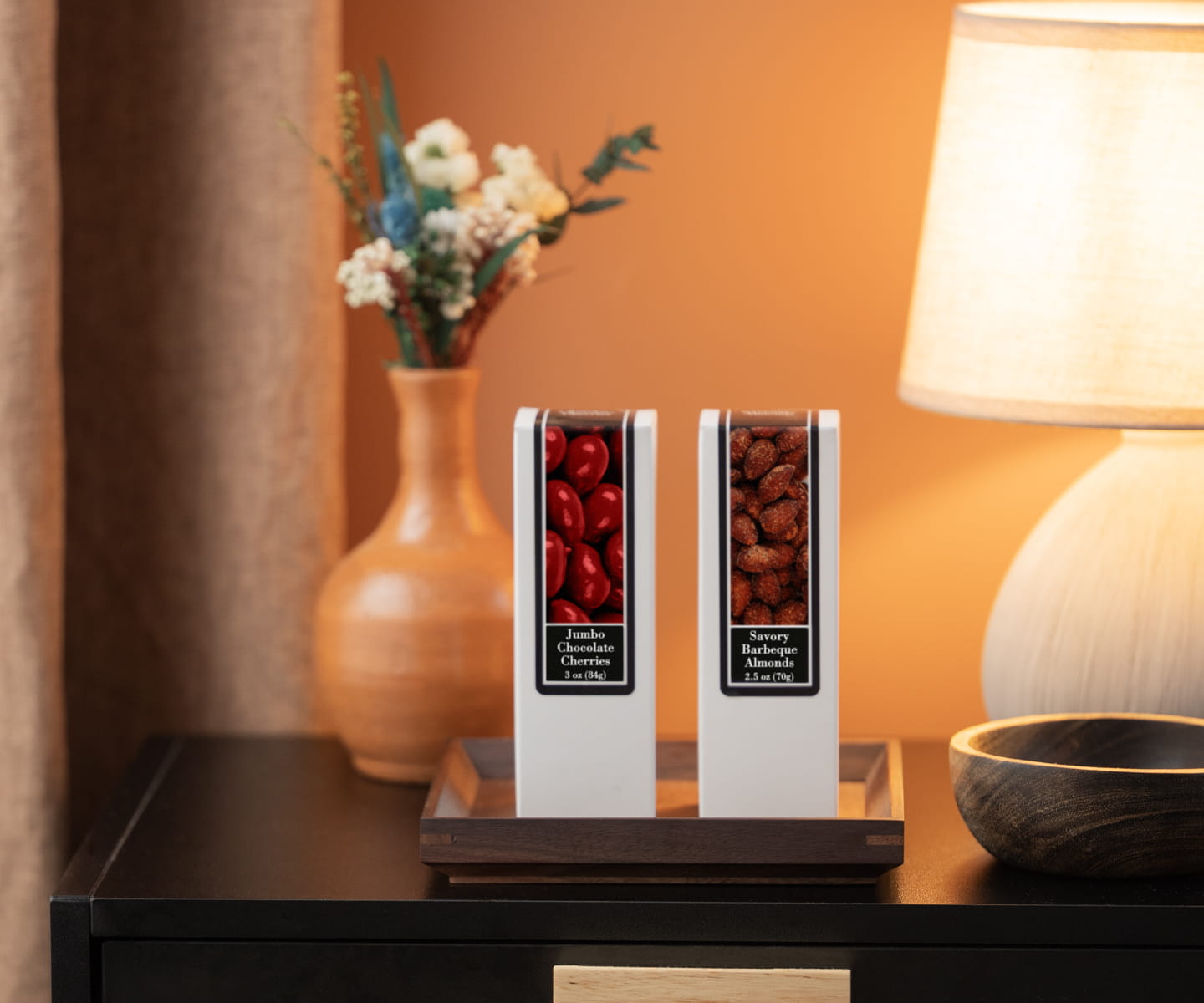 Modern boutique hotel welcome tray with premium snacks and water, representing the trend of complimentary minibar.